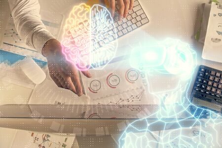 Double exposure of mans hands typing over computer keyboard and virtual reality hologram drawing....
