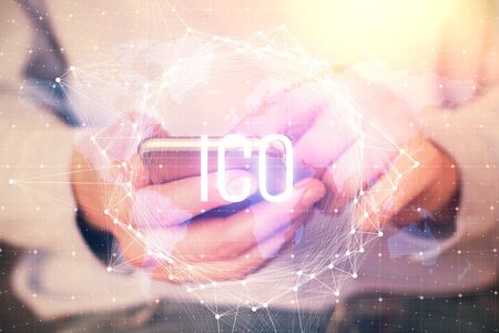 Double exposure of mans hands holding and using a phone and crypto currency blockchain theme drawing.の写真素材