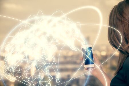 Double exposure of business theme sketch hologram and woman holding and using a mobile device.の写真素材
