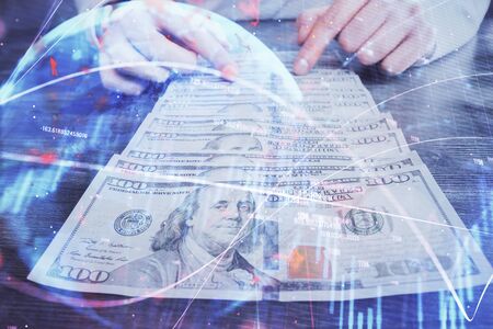 Multi exposure of forex graph drawing hologram and USA dollars bills and man hands. Technical Analysis concept.の写真素材