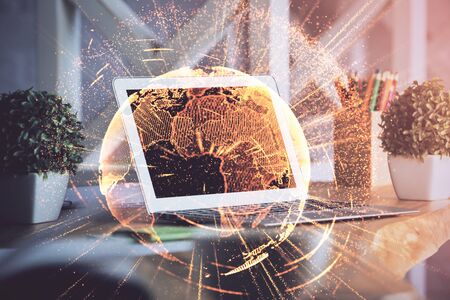 Computer on desktop with social network hologram. Double exposure. Concept of international people connections.の写真素材
