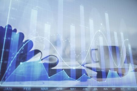 Double exposure of financial chart drawing and desktop with coffee and items on table background....