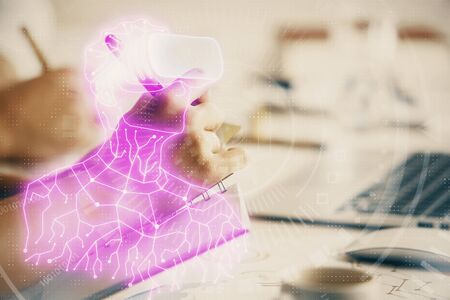 Double exposure of AR glasses drawing over people taking notes background. Concept of VRの写真素材