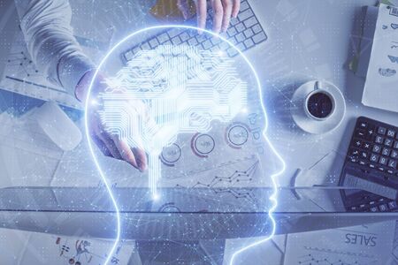Double exposure of mans hands typing over computer keyboard and brain hologram drawing. Top view. Ai...