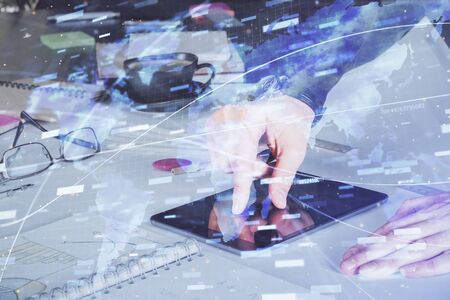Double exposure of mans hand holding and using a digital device and data theme drawing. Technology concept.の写真素材