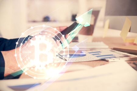Double exposure of mans hands holding and using a phone and crypto currency blockchain theme drawing.の写真素材