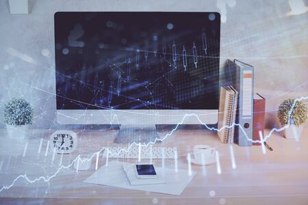 Forex graph hologram on table with computer background. Double exposure. Concept of financial markets.の写真素材