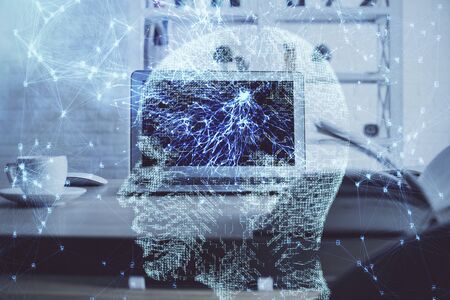 Double exposure of table with computer and brain hologram. Data innovation concept.
