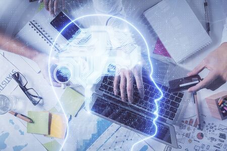 Double exposure of mans hands typing over computer keyboard and brain hologram drawing. Top view. Ai...