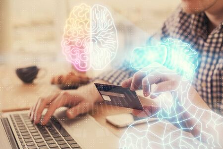 Double exposure of man hands holding a credit card and human in vr glasses drawing. Virtual reality...