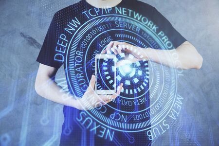 Double exposure of mans hand holding and using a digital device and data theme hologram drawing. Technology concept.の写真素材