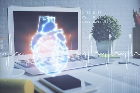 Desktop computer background and heart drawing. Double exposure. Medical study and healthcare concept.の写真素材