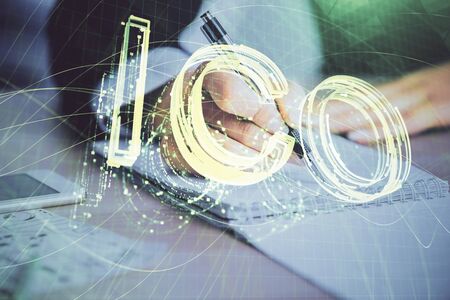 Cryptocurrency hologram over womans hands writing background. Concept of blockchain. Multi exposureの写真素材