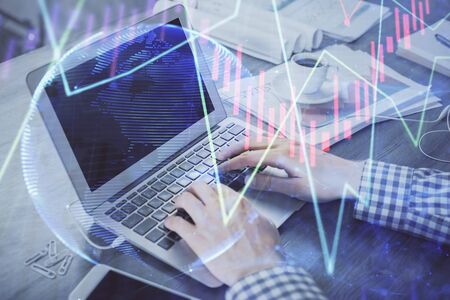 Double exposure of forex graph with man working on computer on background. Concept of market analysis.の写真素材