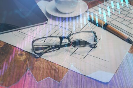 Financial chart hologram with glasses on the table background. Concept of business. Double exposure.の写真素材