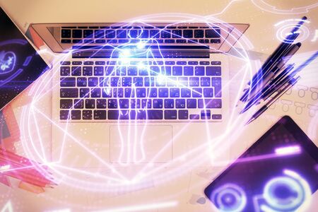 Education hologram drawings over computer on the desktop background. Top view. Multi exposure.の写真素材