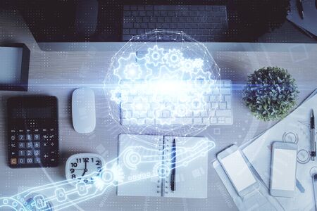 Multi exposure of data drawing hologram over topview of study desk background with computer. Concept...