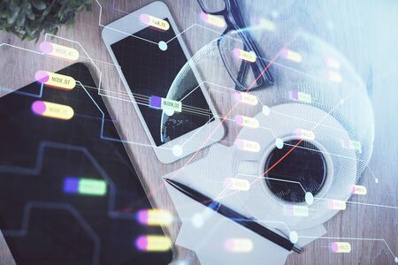 Double exposure of map hologram drawing over desktop. Top view. International connection concept.の写真素材