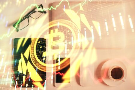 Double exposure of blockchain theme hologram over table with phone. Top view. Crypto technology concept.の写真素材