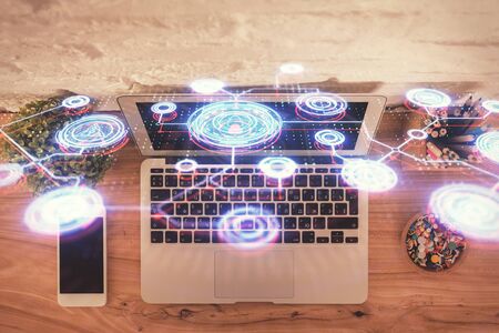Social network hologram drawings over computer on the desktop background. Top view. Multi exposure. Concept of people connection.の写真素材