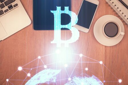 Double exposure of blockchain theme hologram over table with phone. Top view. Crypto technology concept.の写真素材