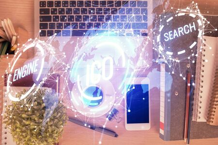 Double exposure of blockchain theme hologram over table with phone. Top view. Crypto technology...