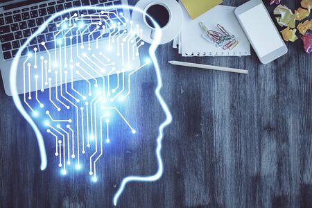 Double exposure of brain drawing hologram over topview work table background with computer. Concept...