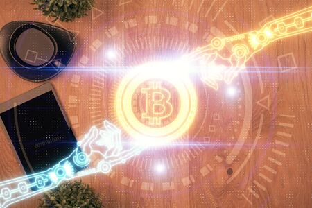Double exposure of blockchain theme hologram over table with phone. Top view. Crypto technology...