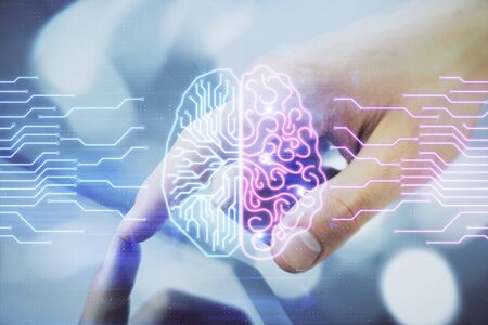 Double exposure of mans hand holding and using a digital device and brain hologram drawing. Data...