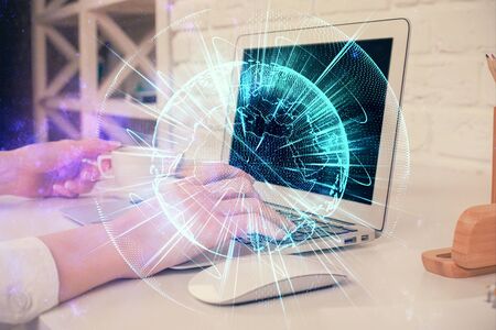 Double exposure of woman hands typing on computer and business theme hologram drawing. Success concept.の写真素材