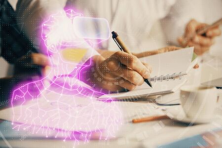 Double exposure of AR glasses drawing over people taking notes background. Concept of VRの写真素材