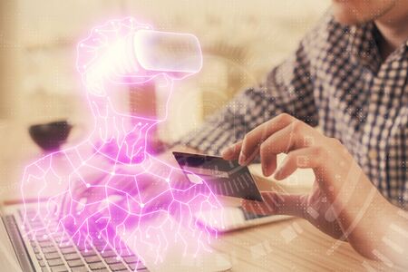 Double exposure of man hands holding a credit card and human in vr glasses drawing. Virtual reality...