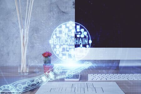 Double exposure of blockchain and crypto economy theme hologram and table with computer background....