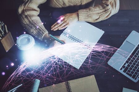Social network theme hologram over womans hands writing background. Concept of international people...