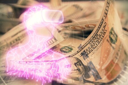Double exposure of man wearing VR glasses drawing over usa dollars bill background. Concept of virtual reality.の写真素材