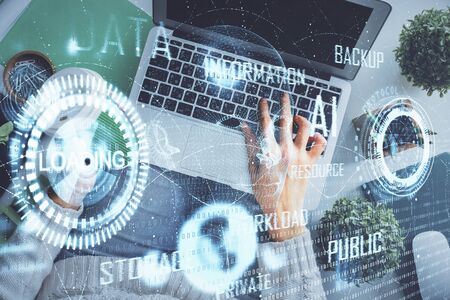 Double exposure of woman hands working on computer and data theme hologram drawing. Top View. Technology concept.の写真素材