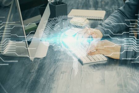 Man with computer background with brain theme hologram. Concept of brainstorm. Double exposure.