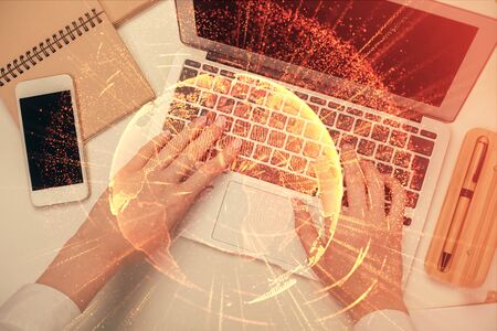Double exposure of woman hands working on computer and social network theme hologram drawing. Top View. People connection concept.の写真素材