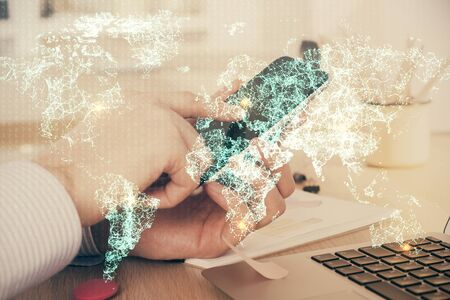 Double exposure of mans hands holding and using a phone and social network theme drawing.の写真素材