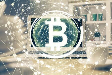 Multi exposure of blockchain theme hologram and table with computer background. Concept of bitcoin crypto currency.の写真素材