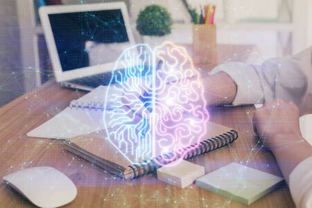 Multi exposure of writing hand on background with brain hologram. Concept of self learning.の写真素材