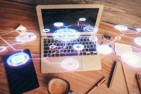 Social network hologram drawings over computer on the desktop background. Top view. Multi exposure. Concept of people connection.の写真素材