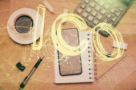 Double exposure of blockchain theme hologram over table with phone. Top view. Crypto technology concept.の写真素材