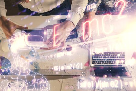 Double exposure of man and woman working together and formula hologram drawing. Computer background....