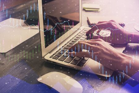 Double exposure of woman hands typing on computer and forex chart hologram drawing. Stock market...