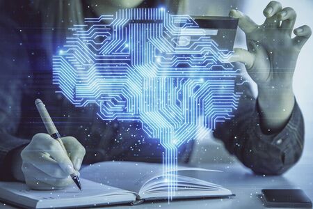 Double exposure of woman on-line shopping holding a credit card and brain hologram drawing. Data E-commerce concept.の写真素材