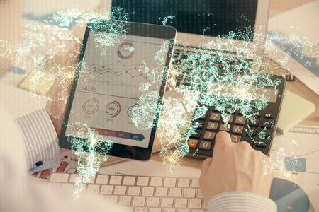 Double exposure of mans hands holding and using a phone and social network theme drawing.の写真素材