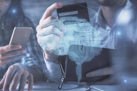 Double exposure of man and woman on-line shopping holding a credit card and brain hologram drawing....