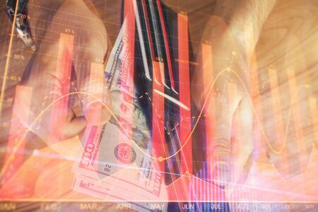 Multi exposure of forex graph drawing hologram and USA dollars bills and man hands. Technical Analysis concept.の写真素材