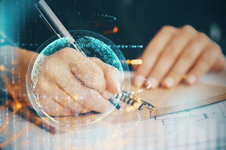 Double exposure of hands making notes with world map hologram and data theme icons. Concept of global computer data.の写真素材